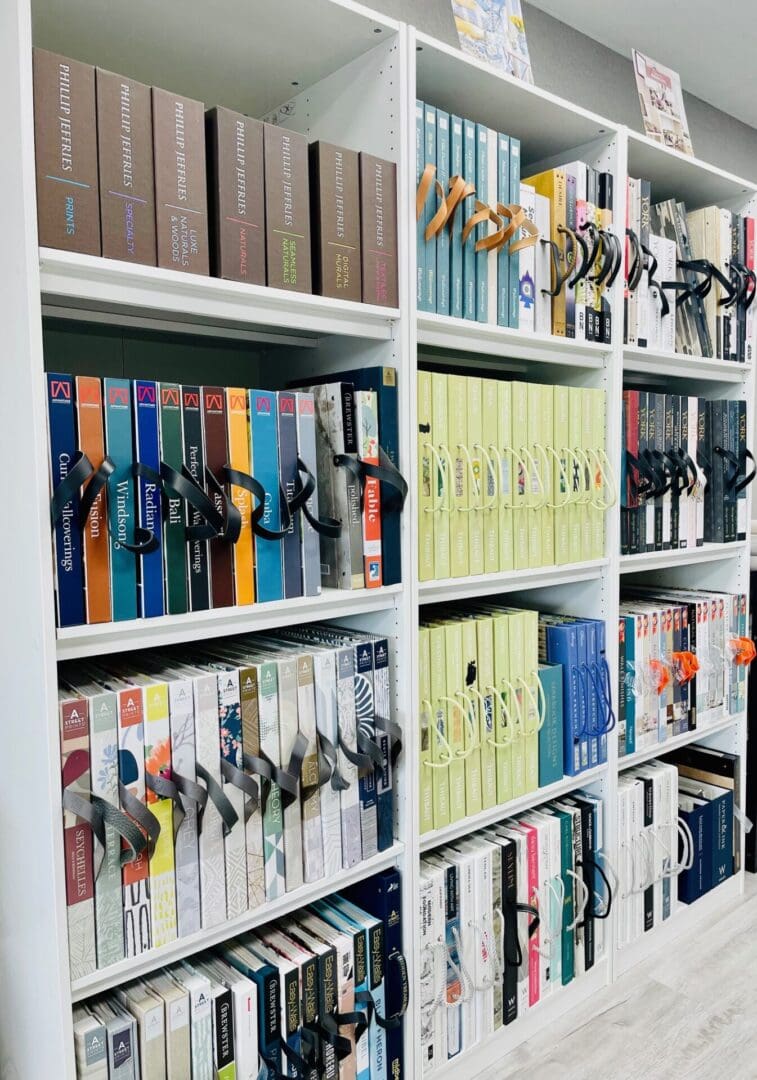 A library with many books and scissors on the shelves.